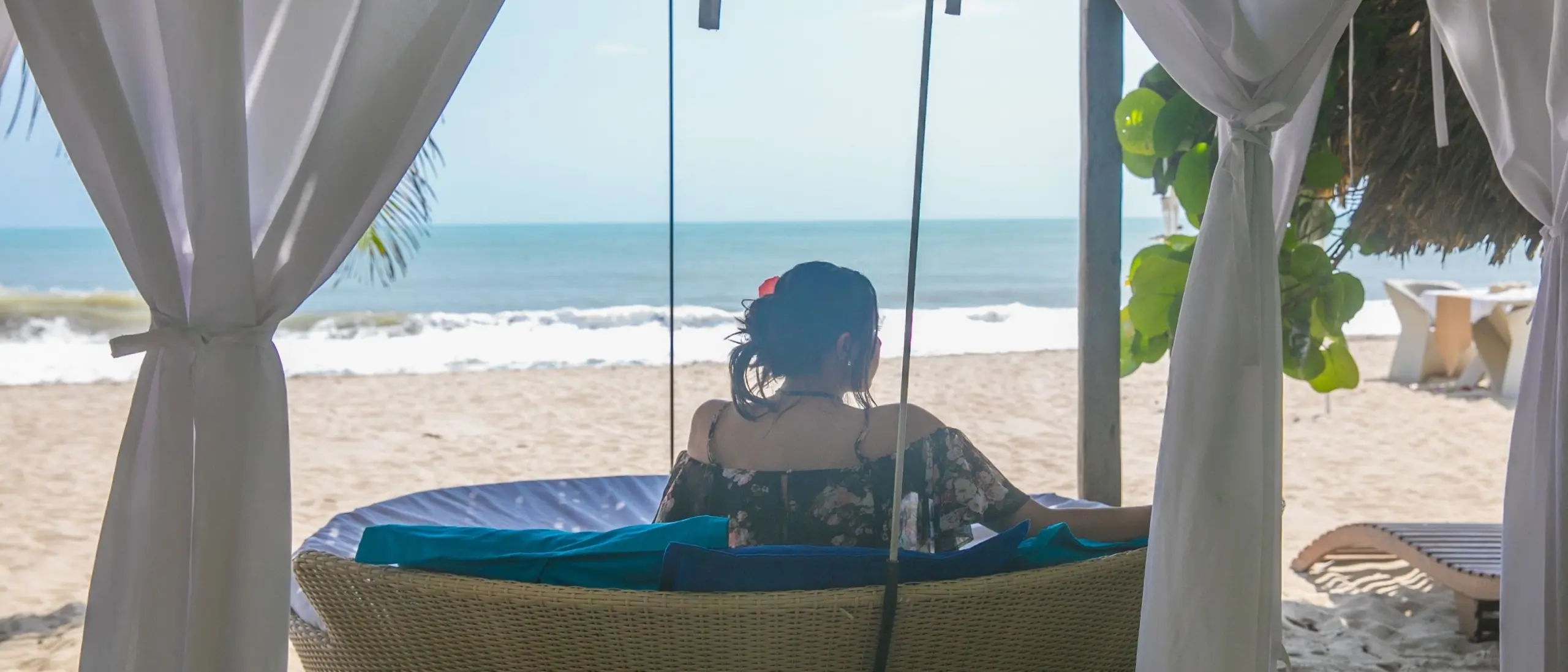 El bungalow desde afuera al atardecer, luz encendida entre la selva – Genn Tayrona